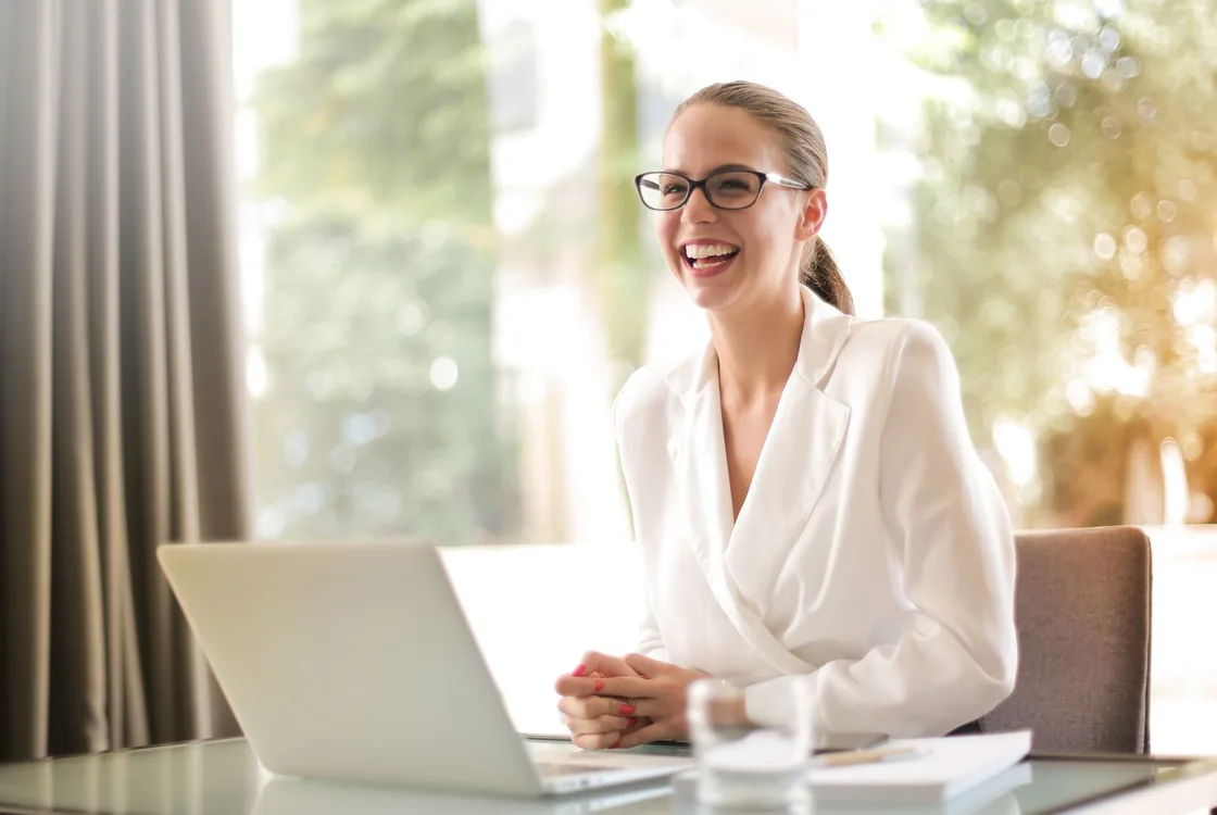 Conseillere bancaire souriante recevant un client a son bureau, formation anglais banque Cabinet Action