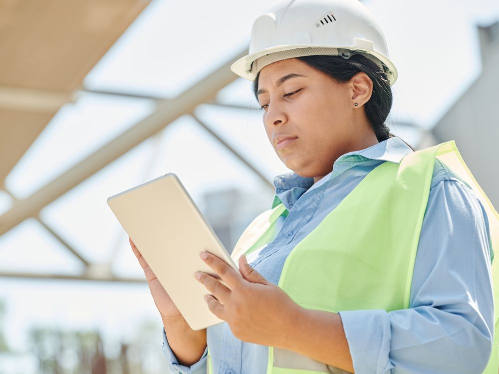 Conductrice de travaux avec tablette sur un chantier, formation anglais du bâtiment et travaux publics